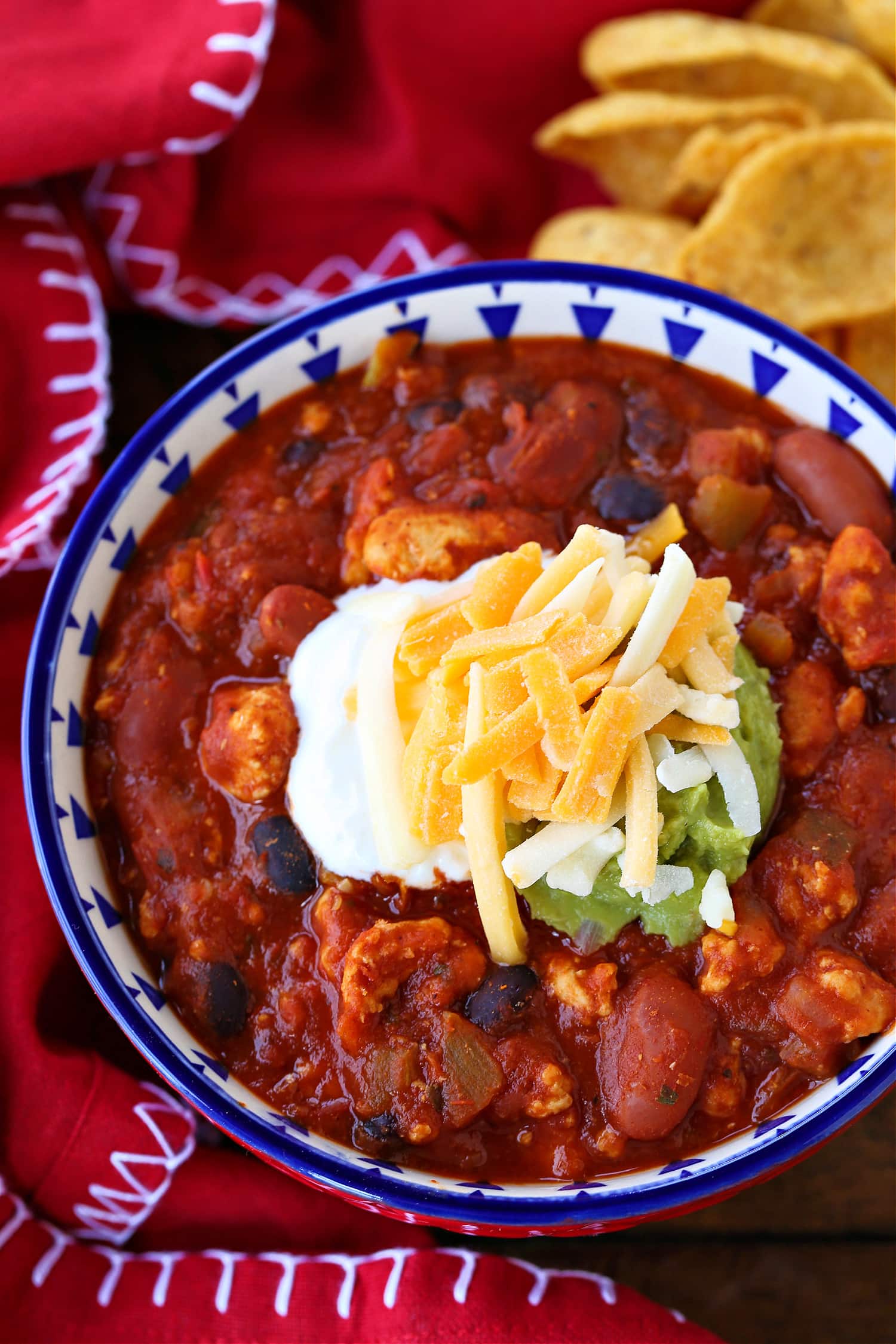 chicken chili in a bowl with chips on the side