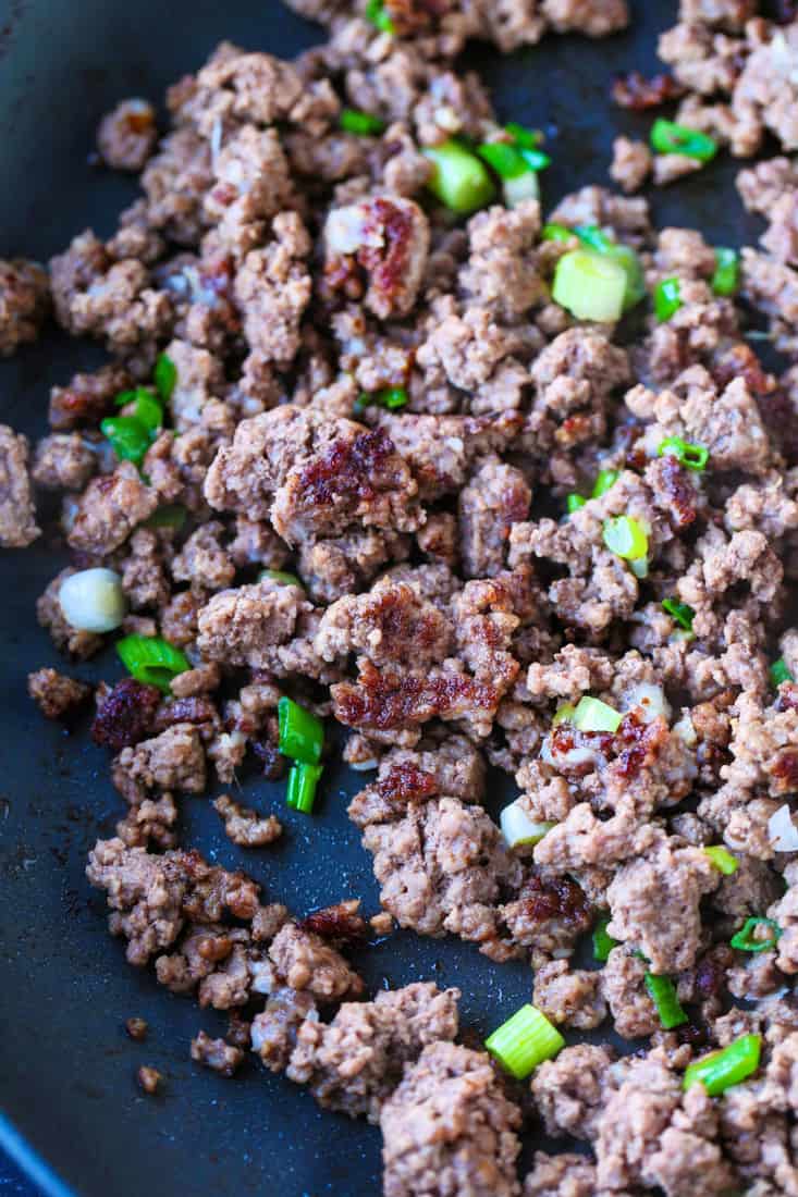 Ground beef with scallions in a skillet