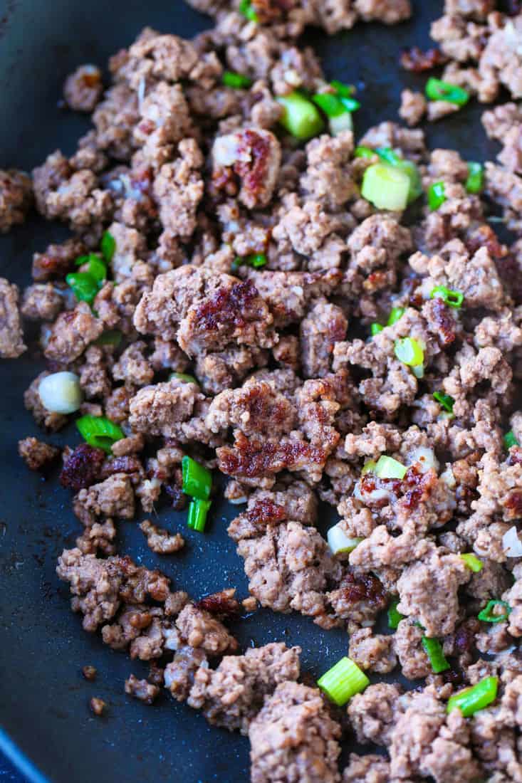 This Ground Beef and Broccoli recipe is SO addicting! Our kids absolutely love this 15 minute dinner, and they always want seconds! Ground beef with scallions in a skillet
