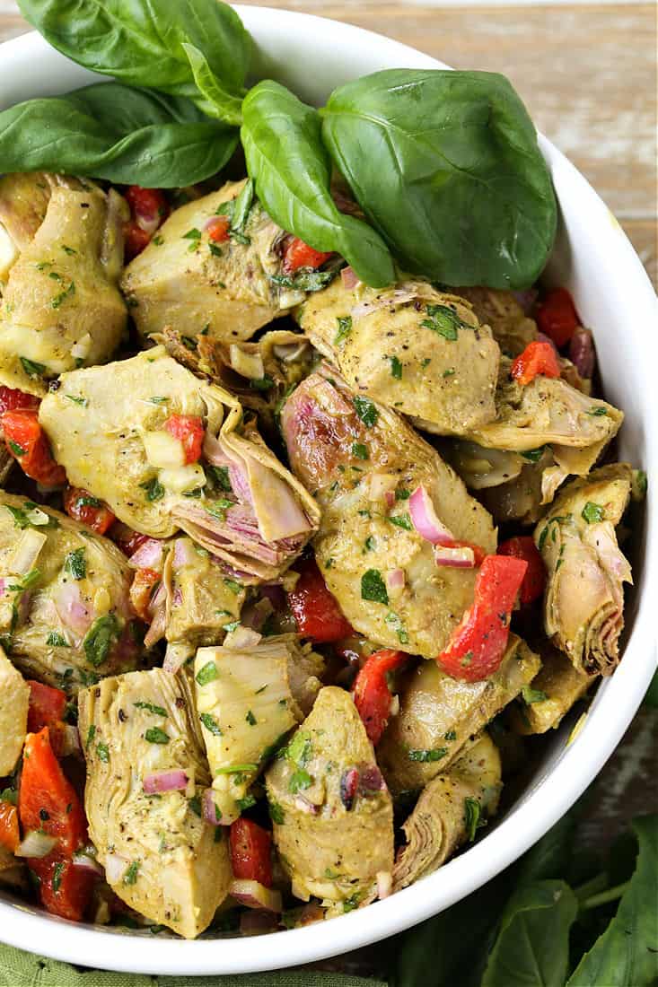 A salad made with roasted artichokes and roasted red peppers