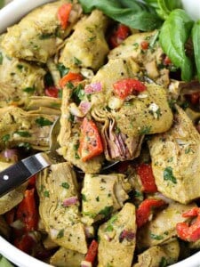 Roasted Artichoke Salad in a bowl with serving spoon