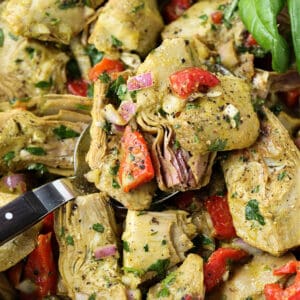 Roasted Artichoke Salad in a bowl with serving spoon