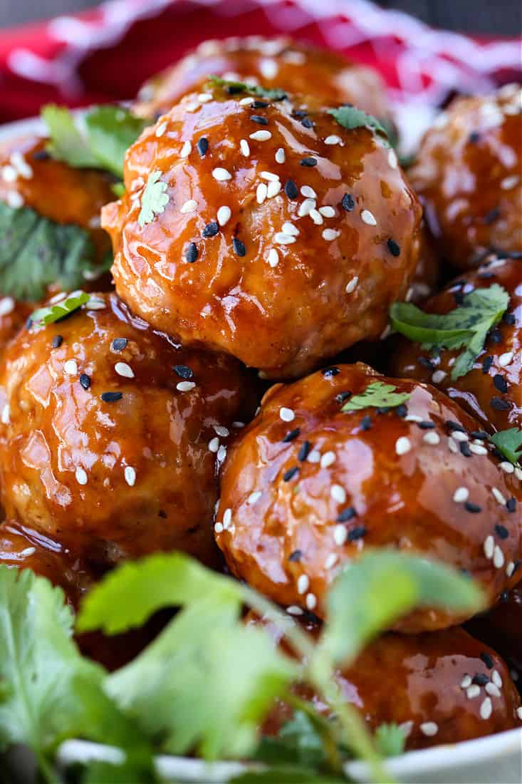 Teriyaki Meatballs in a bowl with sesame seeds and cilantro