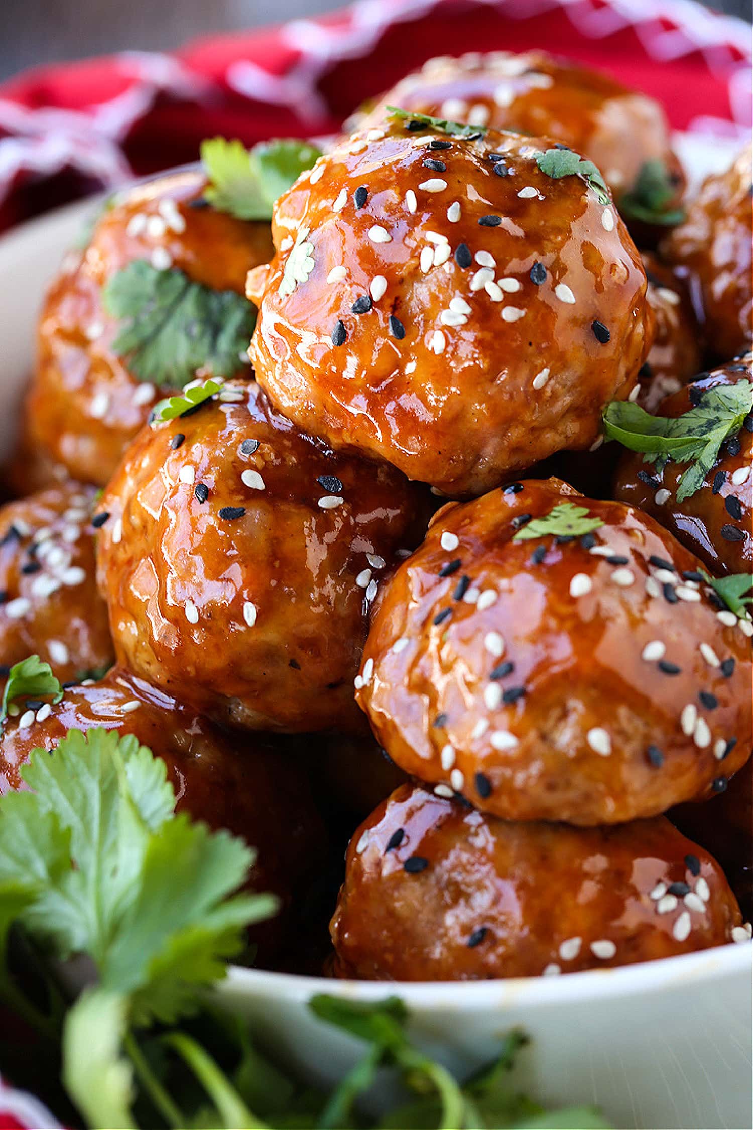 This Teriyaki Meatball recipe is one of our favorite, easy to make dinners! Oven baked, flavorful meatballs tossed in a teriyaki glaze! A Teriyaki Meatball recipe in a bowl with cilantro