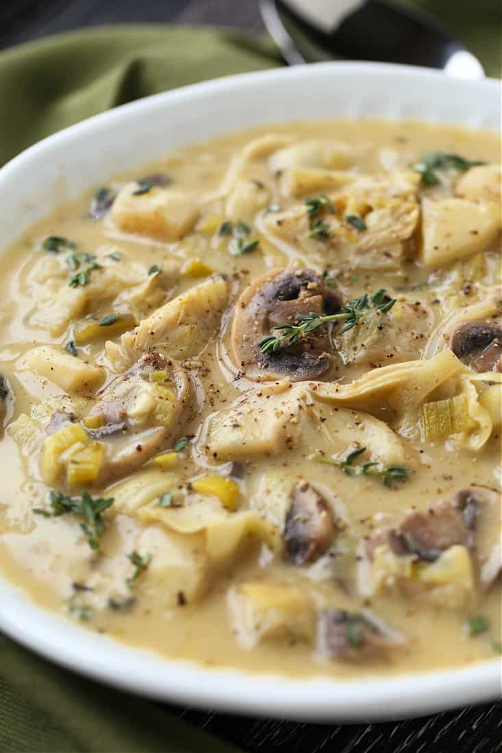 Soup recipe made with artichoke and parsnips in a white bowl