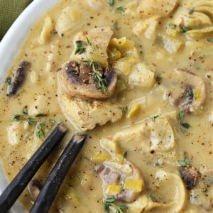 Artichoke soup in a bowl with two spoons