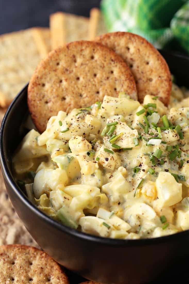 The BEST Egg Salad recipe in a bowl with crackers