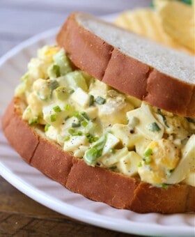 Egg salad sandwich on a white plate