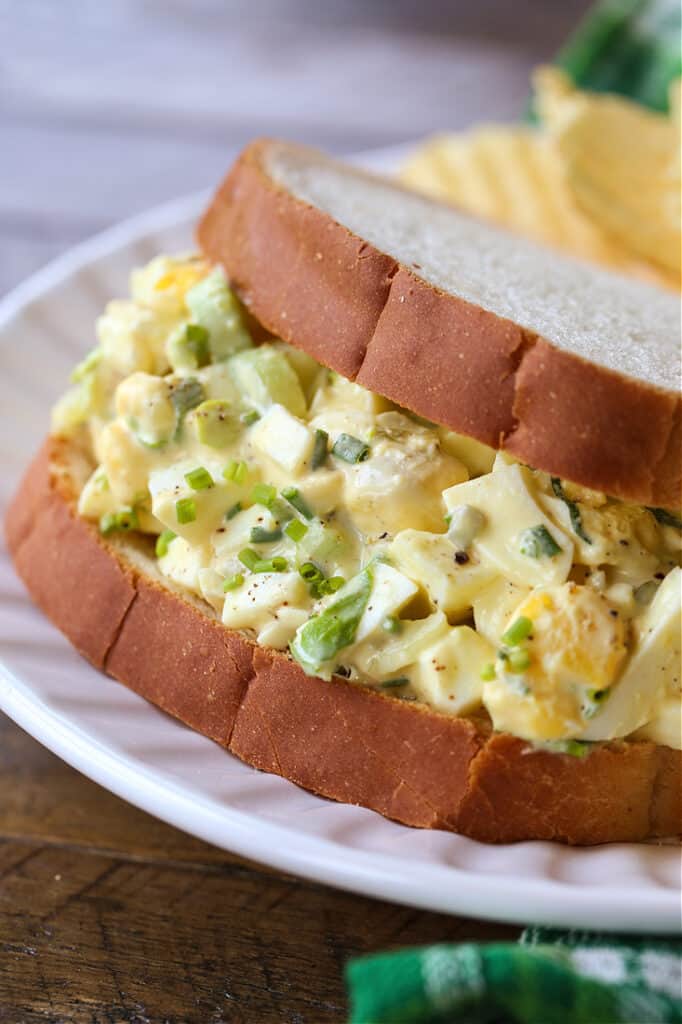 Egg salad sandwich on a white plate