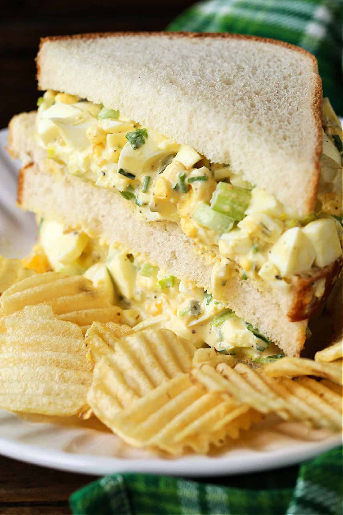 The best egg salad recipe starts with perfectly cooked hard boiled eggs! Deliciously thick, creamy and tangy with just a bit of crunch! egg salad sandwich cut and stacked