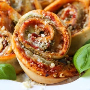 Pizza rolls stuffed with mozzarella cheese, basil pesto and prosciutto