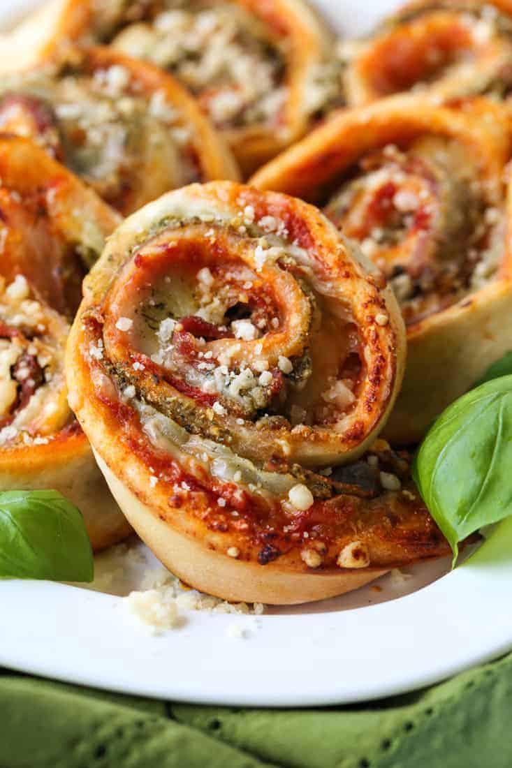 Pizza rolls stuffed with mozzarella cheese, basil pesto and prosciutto