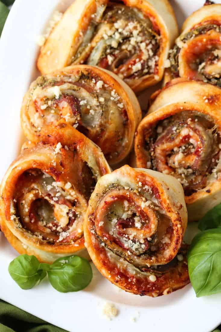 Pizza pinwheels made with mozzarella cheese, basil pesto and prosciutto