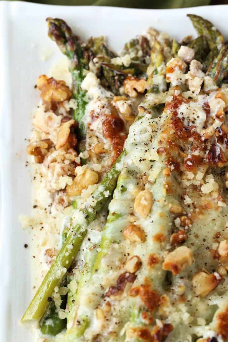 Roasted asparagus topped with mozzarella cheese and toasted walnuts