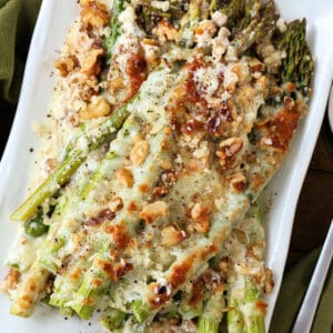 Cheesy Roasted Asparagus on a plate with green napkin