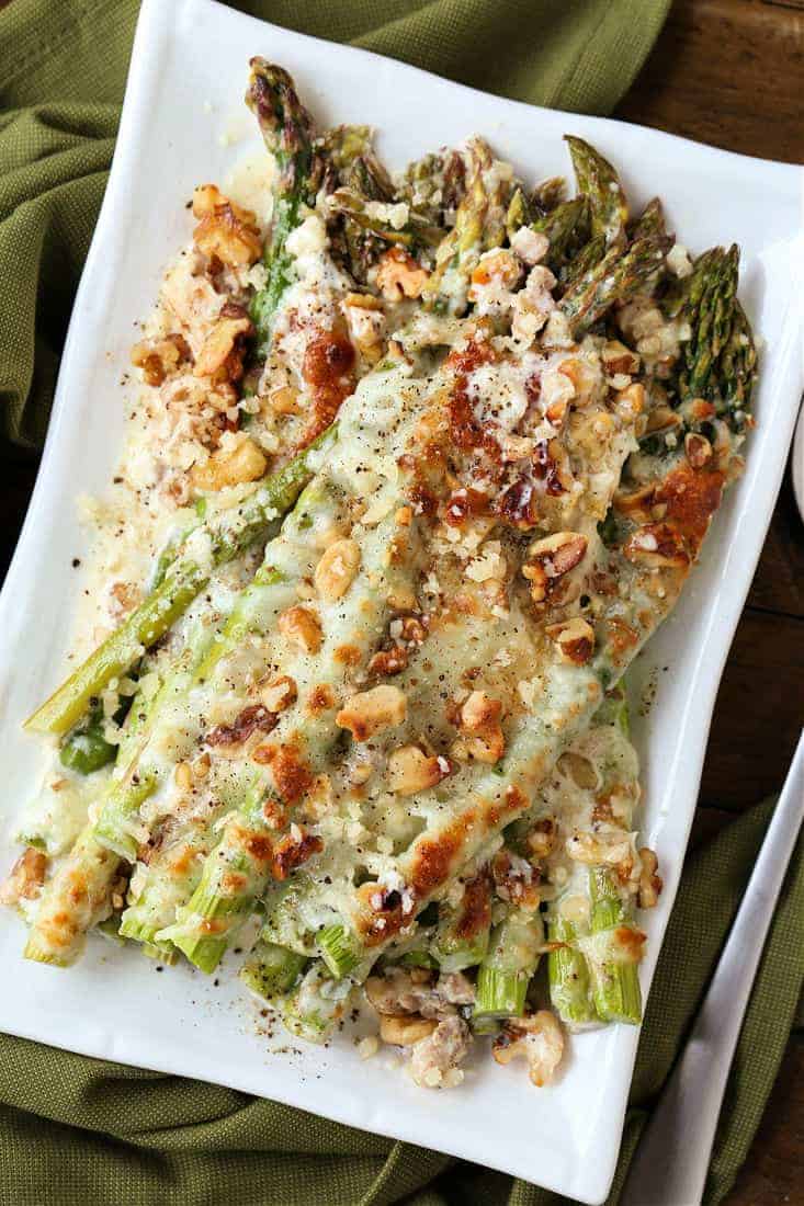 Cheesy Roasted Asparagus on a plate with green napkin