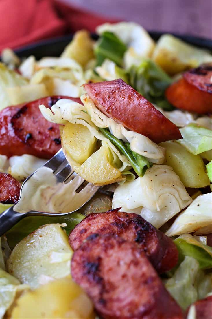 Cabbage, kielbasa and potatoes on a fork