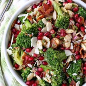 Top view of broccoli salad in a white bowl next to a cloth napkin.