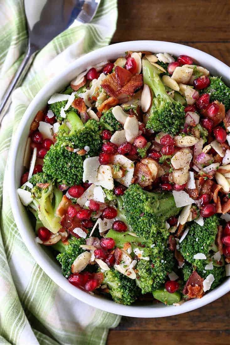 brocoli salad in a white bowl with napkin