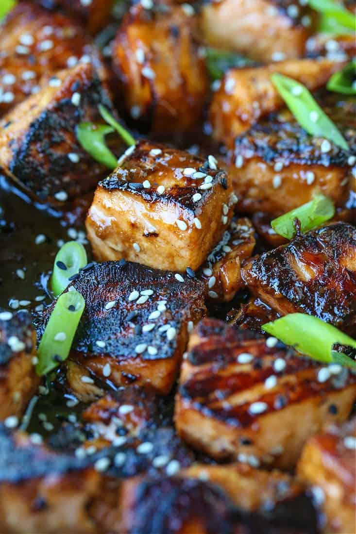 Salmon bites in a teriyaki glaze with scallions