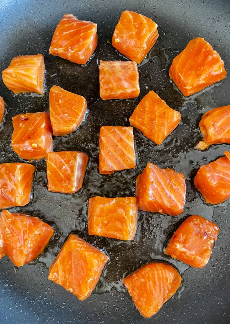Cubes of salmon in a skillet