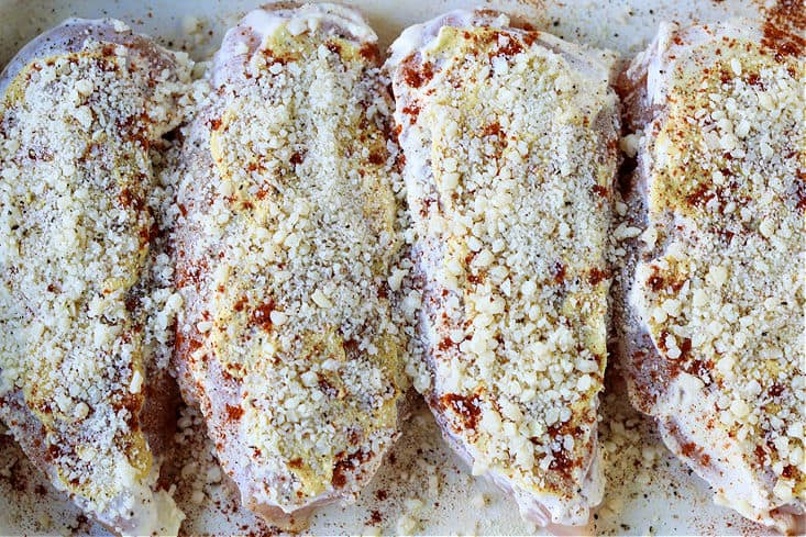 chicken breasts topped with mayonnaise, mustard and grate parmesan cheese