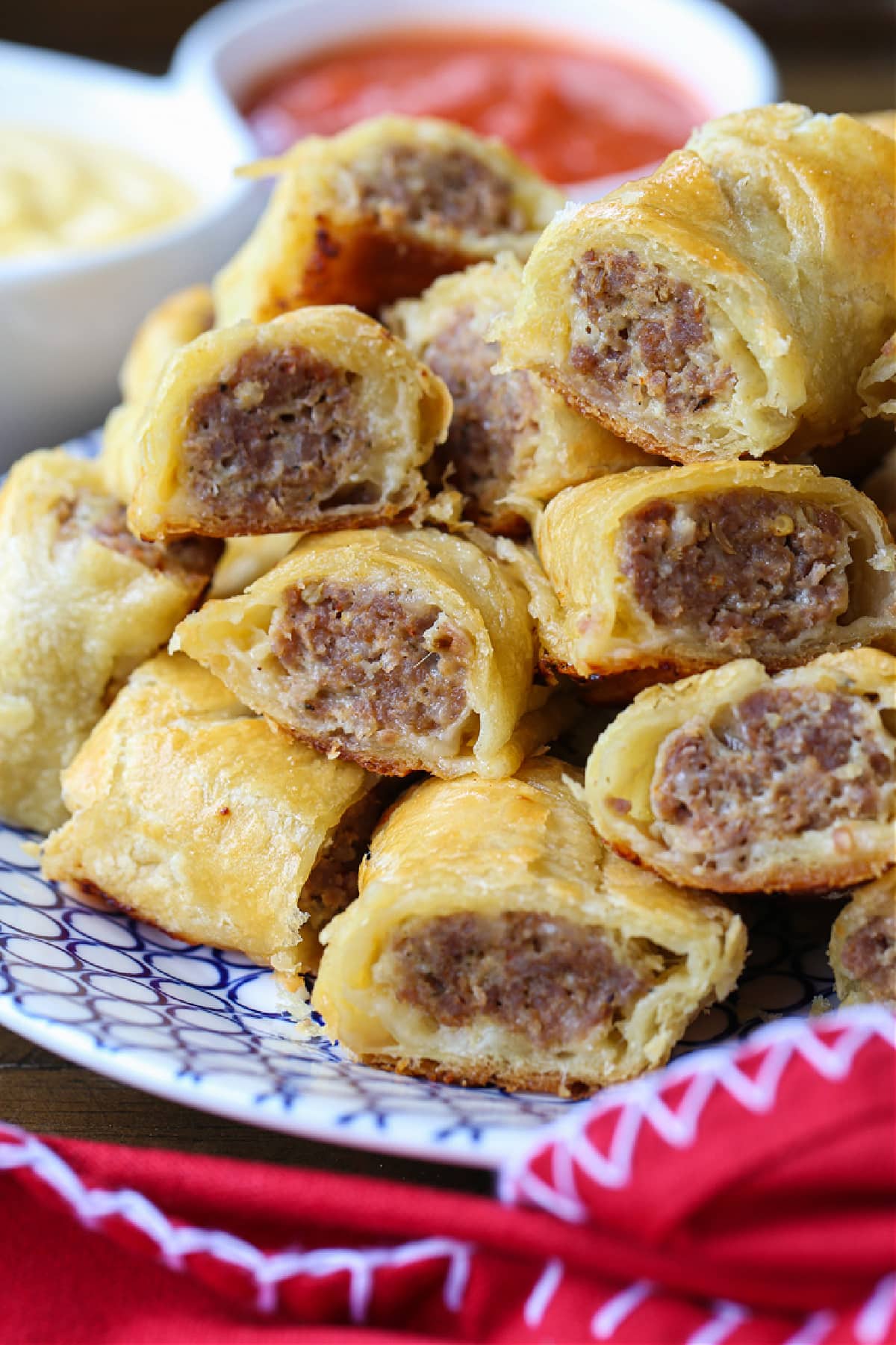 puff pastry sausage rolls stacked on plate