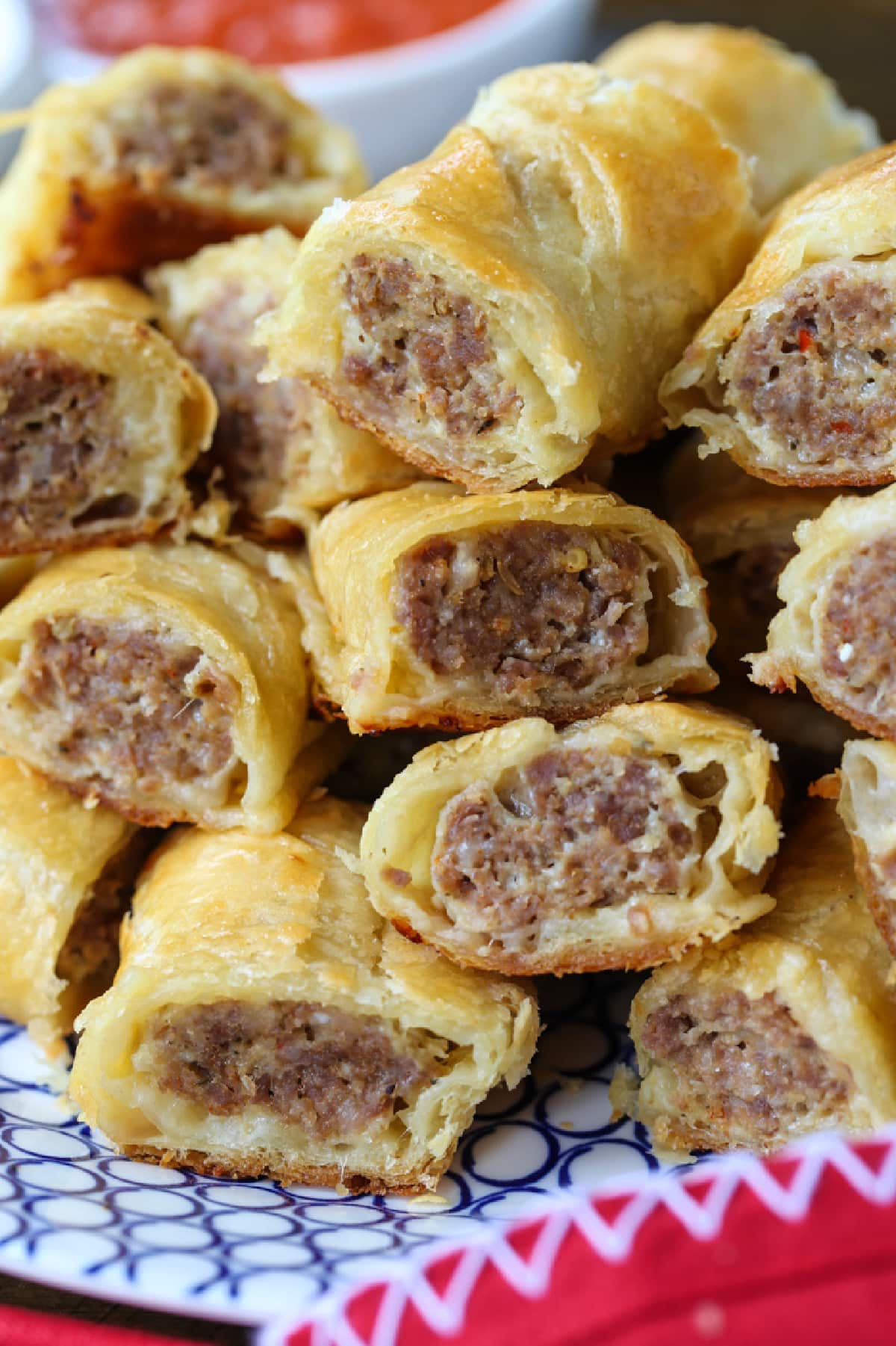 sliced sausage rolls stacked on plate