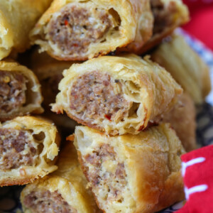 cut sausage rolls stacked on plate