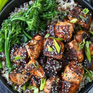 salmon cubed in a bowl with teriyaki glaze and broccoli