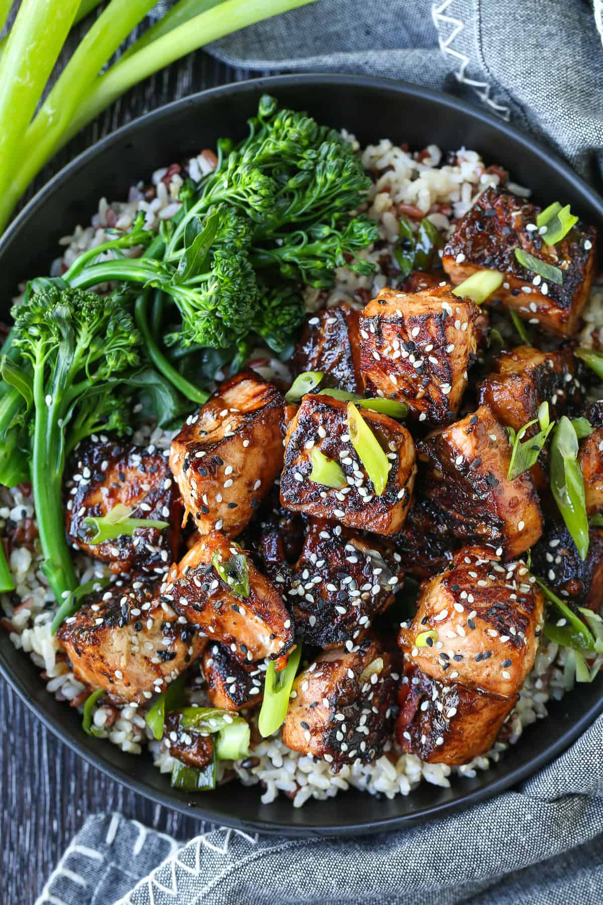 salmon cubed in a bowl with teriyaki glaze and broccoli