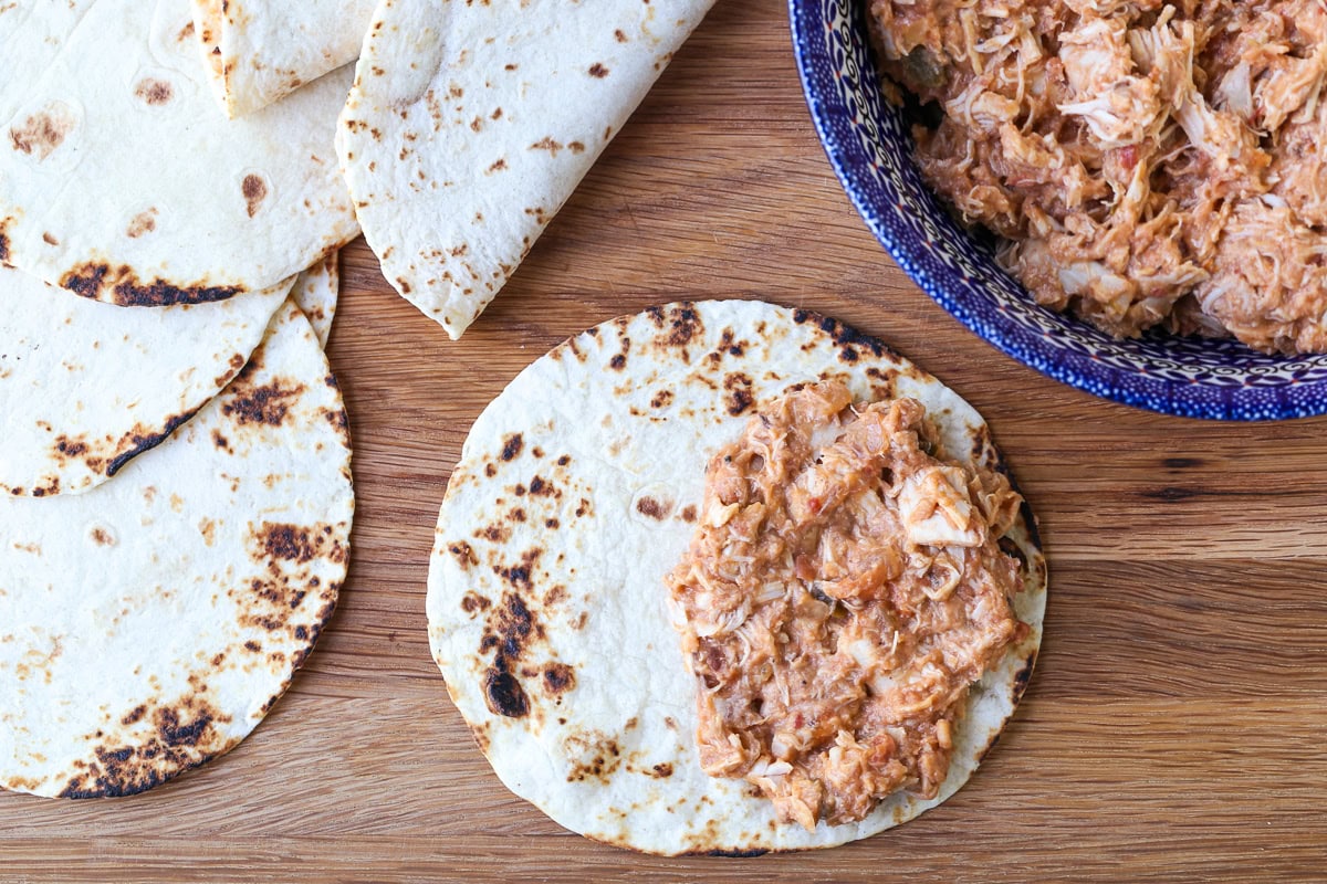 chicken filling on half of a tortilla