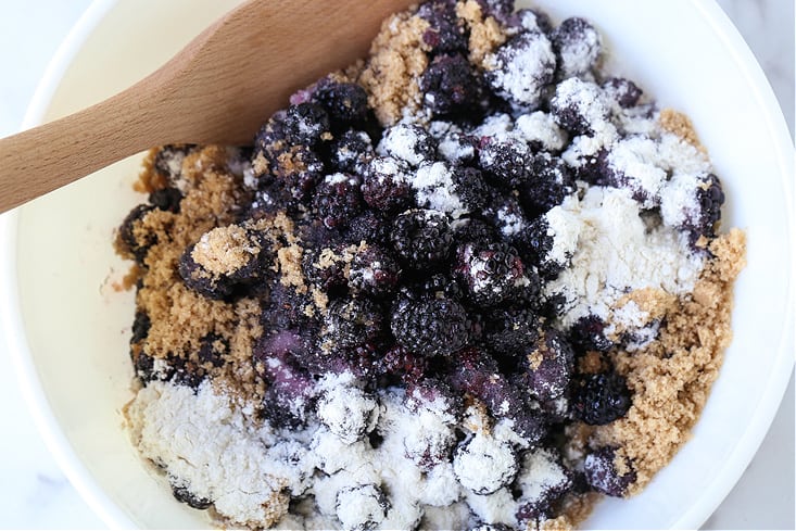 blackberries, brown sugar, flour and oats in a bowl for crisp recipe