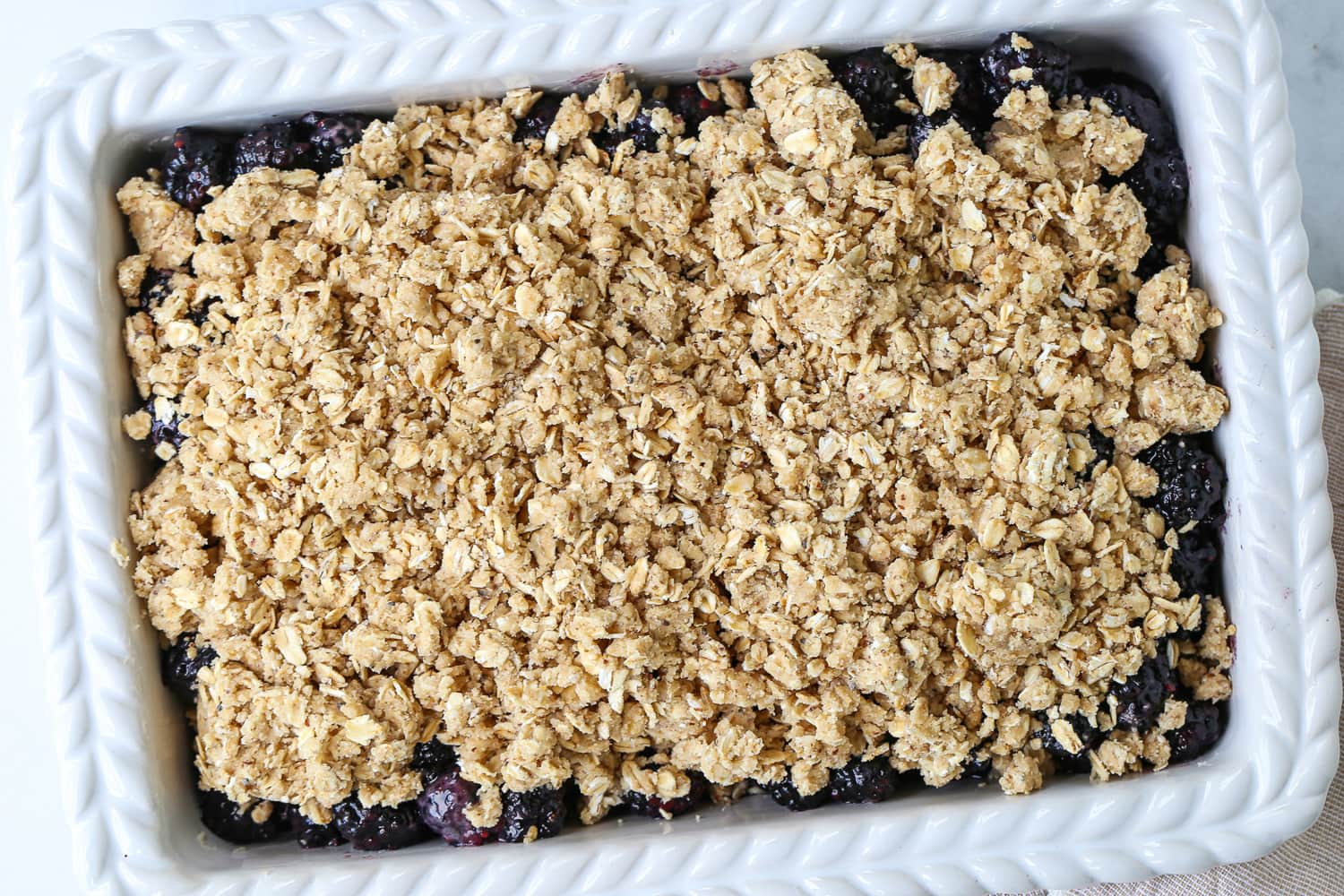 blackberry crisp in a white baking dish