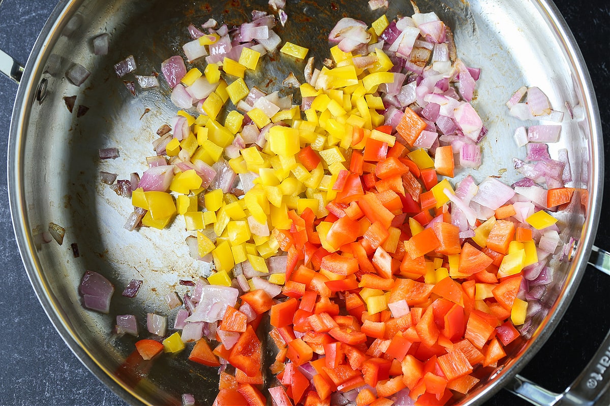 diced onions and bell peppers in a skillet