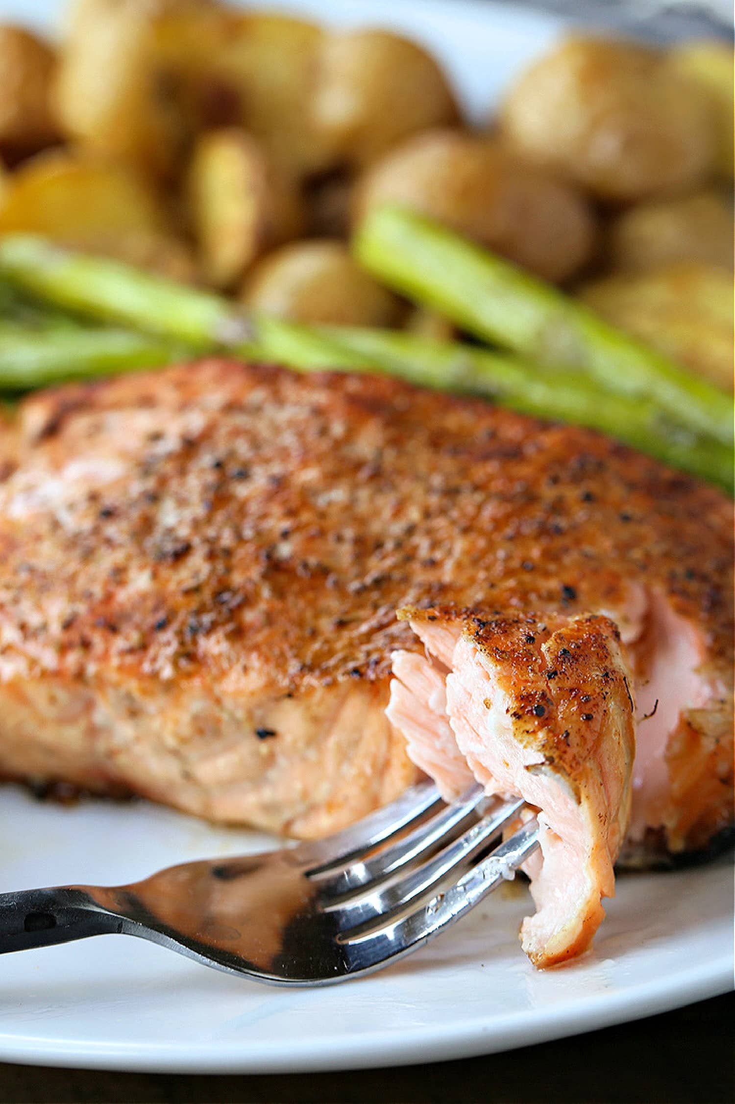 This Easy Grilled Salmon Recipe is the perfect summer dinner! A healthy seafood meal that you can have on the table in 15 minutes! fork with bite of salmon