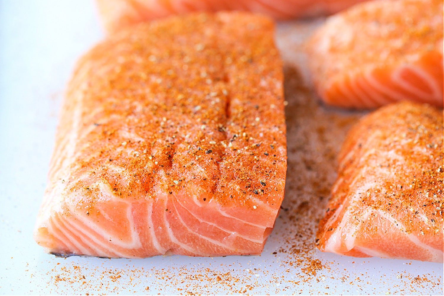 This Easy Grilled Salmon Recipe is the perfect summer dinner! A healthy seafood meal that you can have on the table in 15 minutes! thickness of salmon filet on cutting board