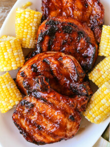 bbq pork chops stacked on a platter