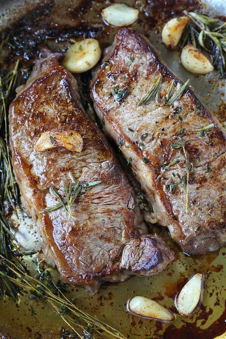 new york strip steak seared with butter and herbs