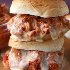 Shredded chicken with sauce and cheese on buns