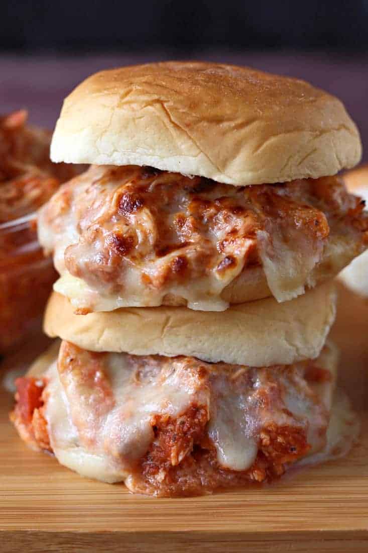 Shredded chicken with sauce and cheese on buns