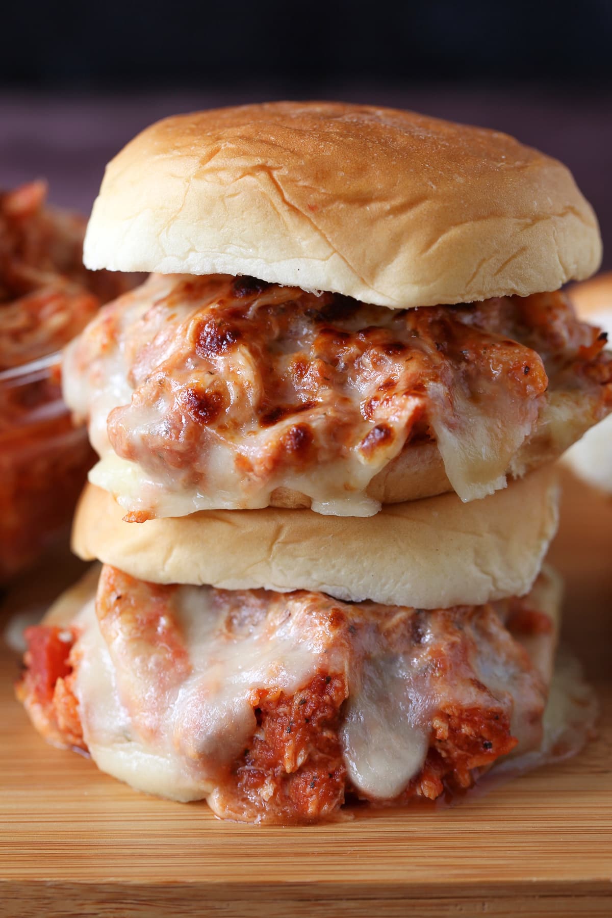 Slow Cooker Chicken Parmesan Sandwiches are an easy dinner for any night of the week! Perfect for meal prepping, game days or holidays! shredded chicken sandwiches with melted mozzarella cheese