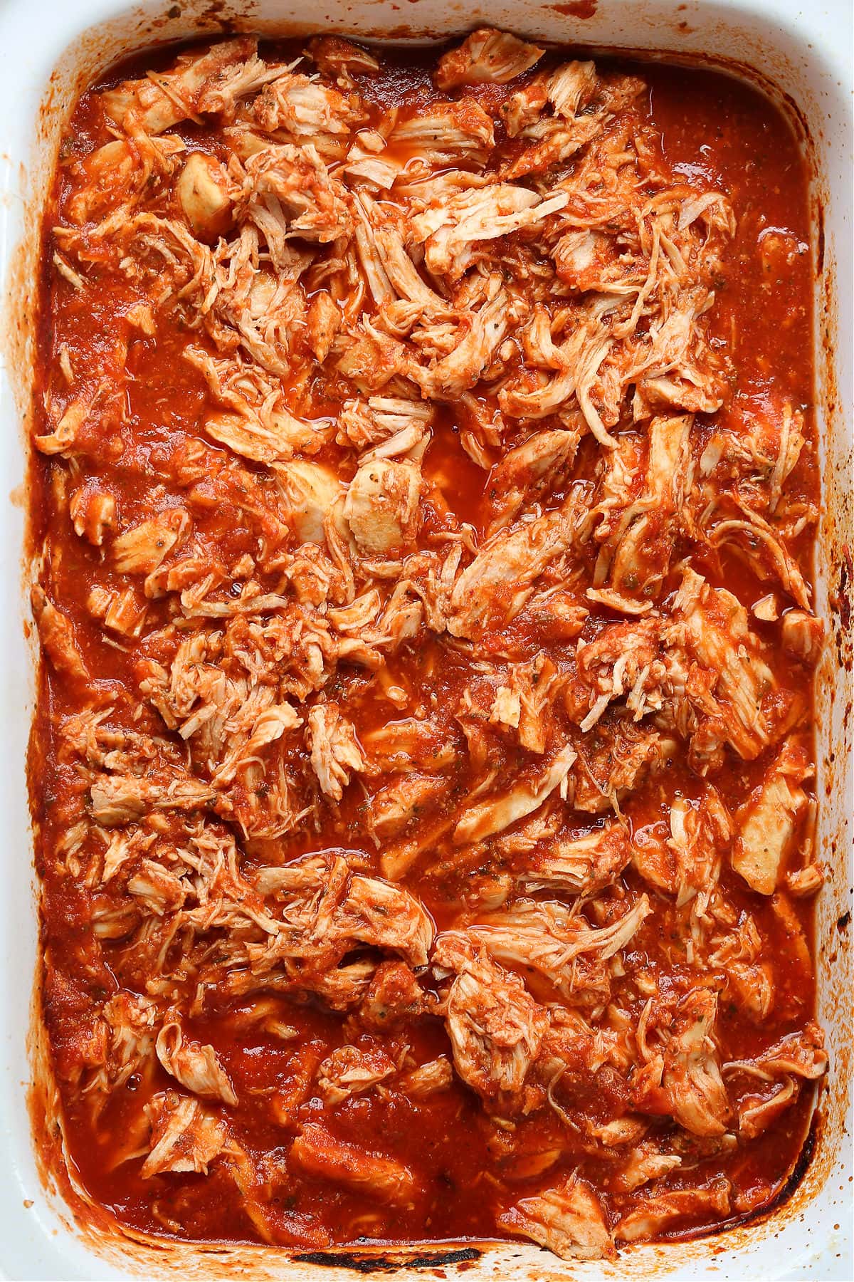 shredded chicken in a slow cooker with marinara sauce