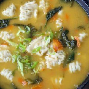 Wonton soup in a bowl with napkin