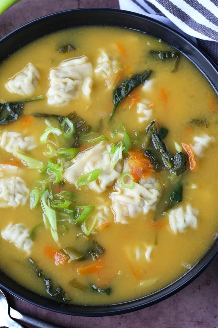 Wonton soup in a bowl with napkin