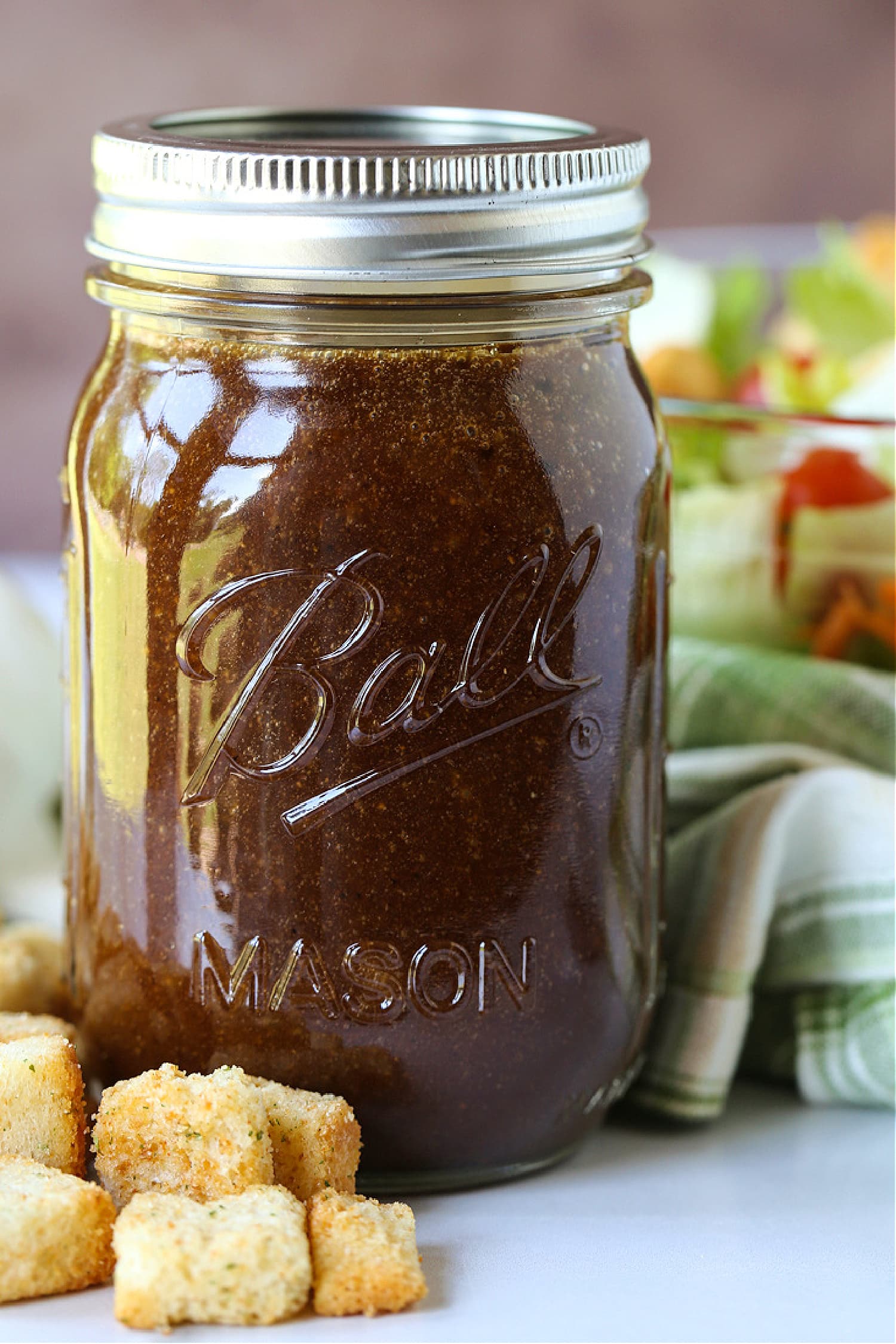 balsamic dressing in a mason jar with salad in background