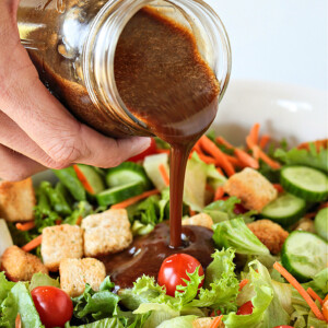 Creamy Balsamic dressing being poured over a salad