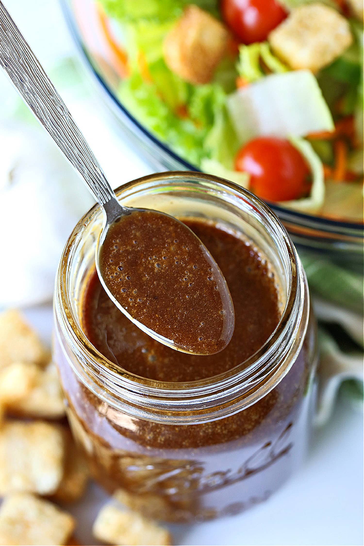 Creamy balsamic dressing in a mason jar with spoon