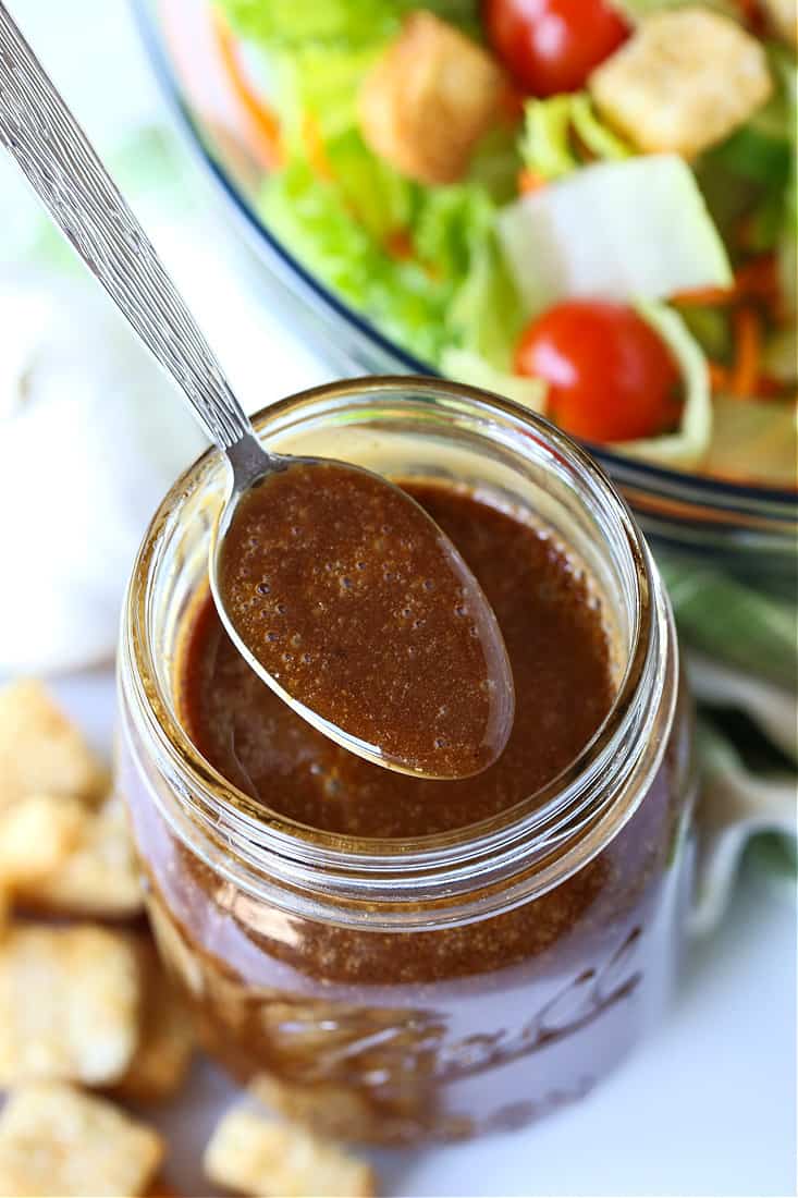 Creamy balsamic dressing in a mason jar with spoon
