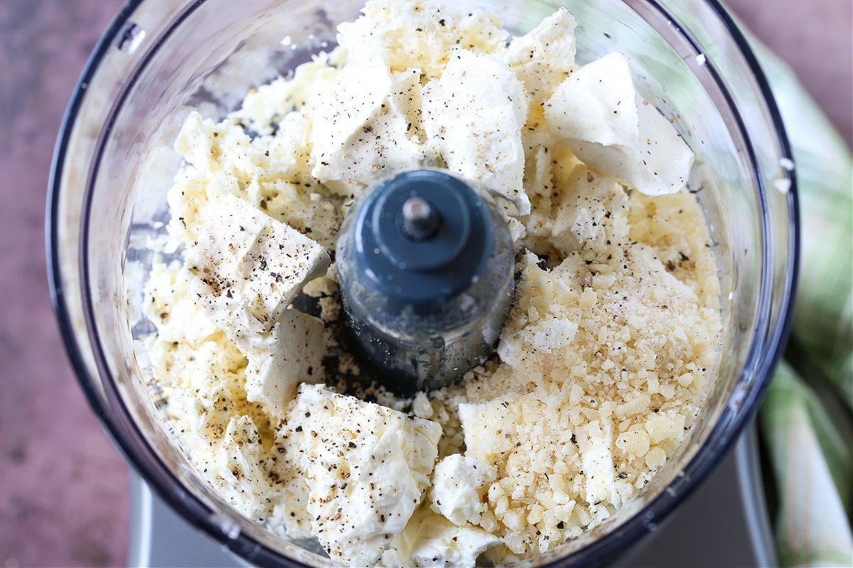 This Feta Bruschetta Recipe is a delicious, easy to make appetizer! Creamy whipped feta combined with a fresh tomato and basil topping! feta and parmesan cheese in food processor
